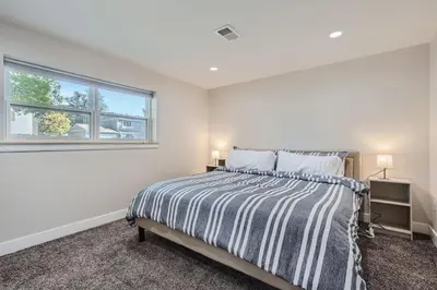 a bedroom with a bed and a window at Charming Family Friendly 4bd 2ba Arvada Home in Arvada