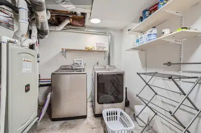 a small kitchen with a stove and a refrigerator at Charming Family Friendly 4bd 2ba Arvada Home in Arvada
