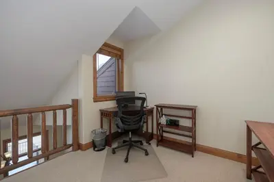 an attic office with a desk and a chair at Luxe MTN Escape 15 min to Winter Park Base in Tabernash