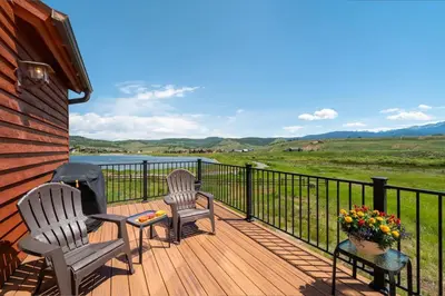 two chairs and a table on a deck with a view at Luxe MTN Escape 15 min to Winter Park Base in Tabernash