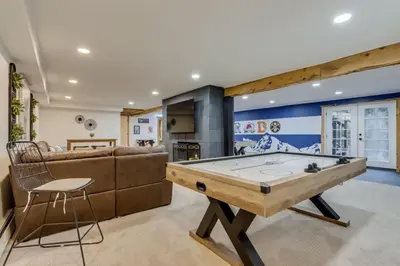 a living room with a pool table and a couch at Mountain Mansion with Hot Tub and Sauna in Morrison