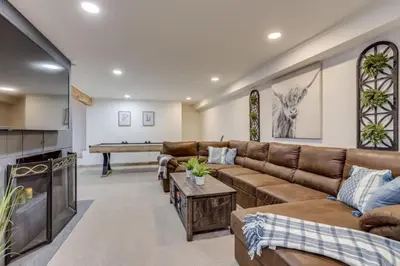 a living room with a couch and a table at Mountain Mansion with Hot Tub and Sauna in Morrison