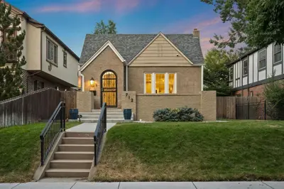 a house with a gate and stairs in a yard at DU Cherry Creek Bungalow Sleeps 4 in Denver