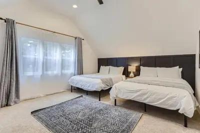 a bedroom with two beds and a large window at RINO Five Points Downtown in Denver