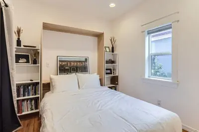 a bedroom with a large white bed and a window at RINO Five Points Downtown in Denver