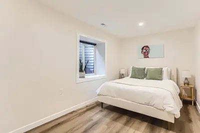 a white bedroom with a bed and a window at RINO Five Points Downtown in Denver