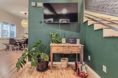 a living room with a desk and a guitar in a room at RINO Five Points Downtown in Denver