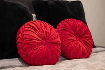 two red pillows on a bed with black pillows at Winter Park Chalet I Mtn Biking I Summer festivals in Winter Park