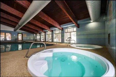 a large bathroom with a tub and a swimming pool at Winter Park Chalet I Mtn Biking I Summer festivals in Winter Park