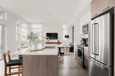 a kitchen with white walls and a large white counter top at 2880 Rhythm of the Night Loft at Espadin in Denver