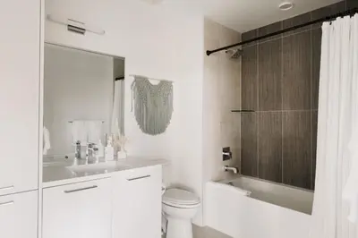 a white bathroom with a toilet and a sink at 2880 Rhythm of the Night Loft at Espadin in Denver