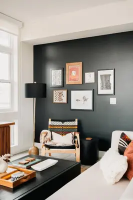 a living room with a black accent wall and a table at 2880 Rhythm of the Night Loft at Espadin in Denver
