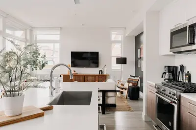 a white kitchen with a sink and a stove at 2880 Rhythm of the Night Loft at Espadin in Denver