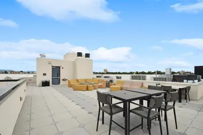 a patio with tables and chairs on a roof at 2880 Japandi Minimalism at Espadin in Denver