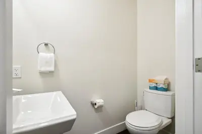 a white bathroom with a toilet and a sink at 2880 Japandi Minimalism at Espadin in Denver