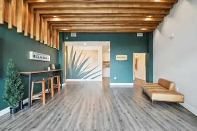 a lobby with green walls and wooden ceilings at 2880 Japandi Minimalism at Espadin in Denver
