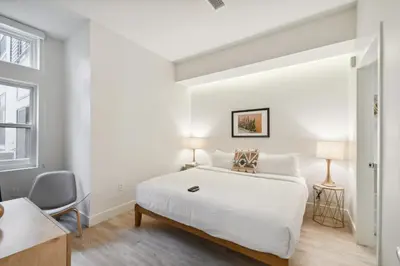 a white bedroom with a large bed and a window at 2880 Natural Influence Sanctuary at Espadin in Denver
