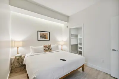 a bedroom with a large white bed and two lamps at 2880 Natural Influence Sanctuary at Espadin in Denver