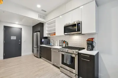a kitchen with stainless steel appliances and white cabinets at 2880 Natural Influence Sanctuary at Espadin in Denver