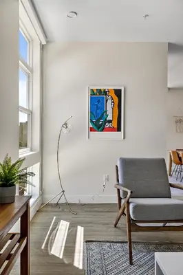 a living room with a chair and a painting on the wall at 2880 Modern Lifestyle Loft at Espadin in Denver