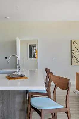a kitchen with two chairs and a counter with a sink at 2880 Modern Lifestyle Loft at Espadin in Denver