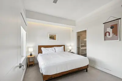 a white bedroom with a bed and a closet at 2880 Sophistication Simplified at Espadin in Denver