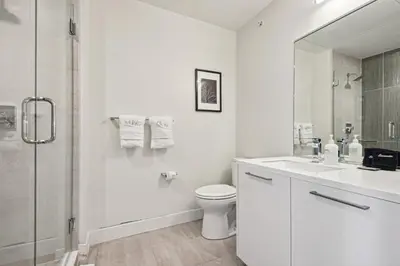 a white bathroom with a toilet and a shower at 2880 Sophistication Simplified at Espadin in Denver