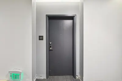 a black door in a hallway with a trash can at 2880 Sophistication Simplified at Espadin in Denver