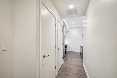 a hallway with white walls and wood floors at 2880 Sophistication Simplified at Espadin in Denver