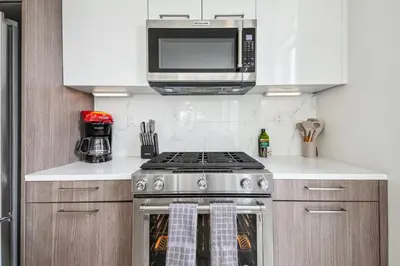 a kitchen with a stove and a microwave at 2880 Highline Hideaway at Espadin in Denver