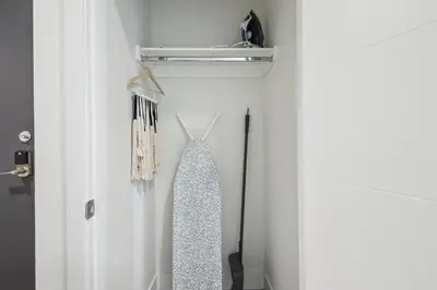 a closet with a tie hanging on a door at 2880 Highline Hideaway at Espadin in Denver