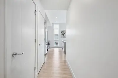 a hallway with white walls and a wooden floor at 2880 Highline Hideaway at Espadin in Denver