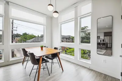 a dining room with a table and chairs and windows at 2880 Highline Hideaway at Espadin in Denver