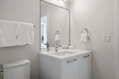a white bathroom with a sink and a mirror at 2880 Sky-High LoHi Oasis at Espadin in Denver