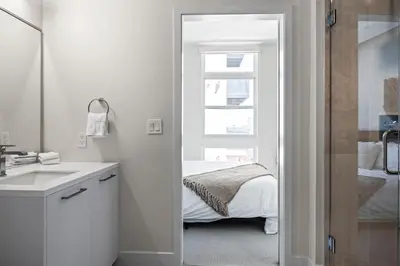 a bathroom with a sink and a bed with a window at 2880 Sky-High LoHi Oasis at Espadin in Denver