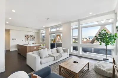 a living room with a couch and a table at 2880 Rose All Day at Espadin in Denver