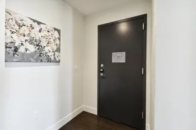 a black door in a room with a painting at 2880 Rose All Day at Espadin in Denver