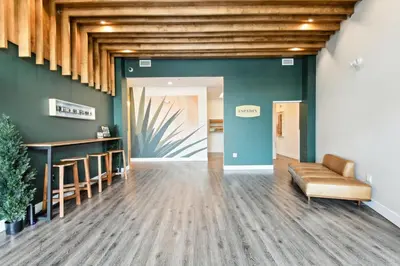 a lobby with a couch and a bar in a building at 2880 Rose All Day at Espadin in Denver