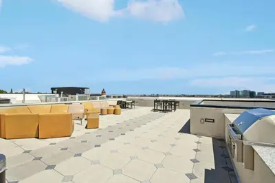 a patio with yellow chairs and tables on a roof at 2880 Rose All Day at Espadin in Denver