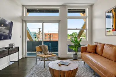 a living room with a couch and a table at 2880 Canvas & Comfort at Espadin in Denver