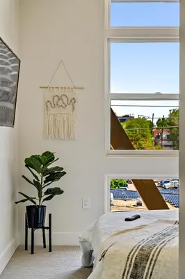 a bedroom with a bed and a window and a plant at 2880 Canvas & Comfort at Espadin in Denver