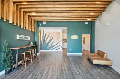 a lobby with green walls and a wooden ceiling at 2880 Sky Edge Suite at Espadin in Denver
