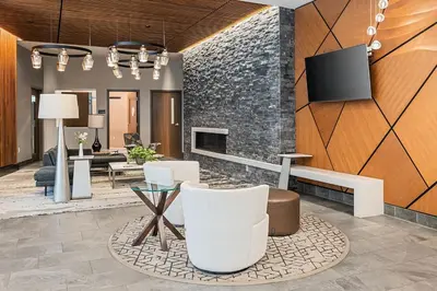 a lobby with a fireplace and a tv on a wall at City Center Oasis Prime Location with Views in Denver
