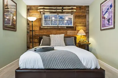 a bedroom with a bed with a window above it at City Center Oasis Prime Location with Views in Denver