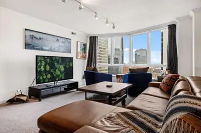 a living room with a couch and a tv at City Center Oasis Prime Location with Views in Denver