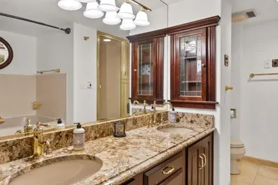 a bathroom with two sinks and a large mirror at City Center Oasis Prime Location with Views in Denver
