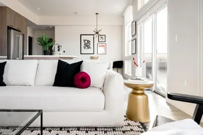 a living room with a white couch with a pink pillow at 2880 Serenity in Style in Denver