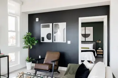 a bedroom with black walls and a bed with a mirror at 2880 Serenity in Style in Denver
