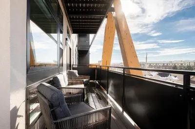 a balcony with chairs on a building with a view at 2880 Serenity in Style in Denver