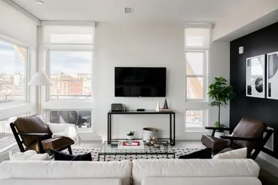 a living room with a white couch and chairs at 2880 Serenity in Style in Denver